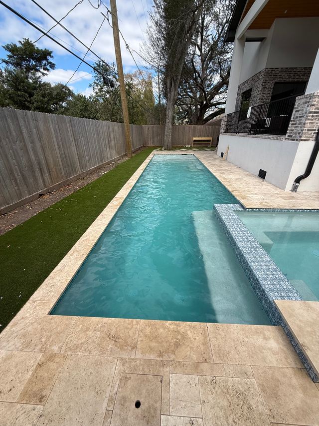 After: the same long pool with clear water and a clean floor