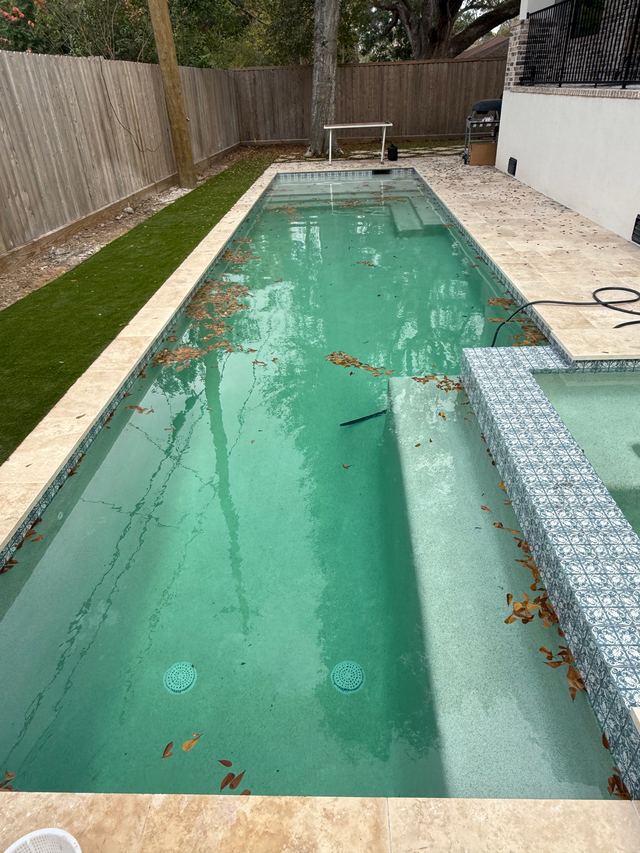 Before: long pool with cloudy, green-tinted water and leaves on the floor