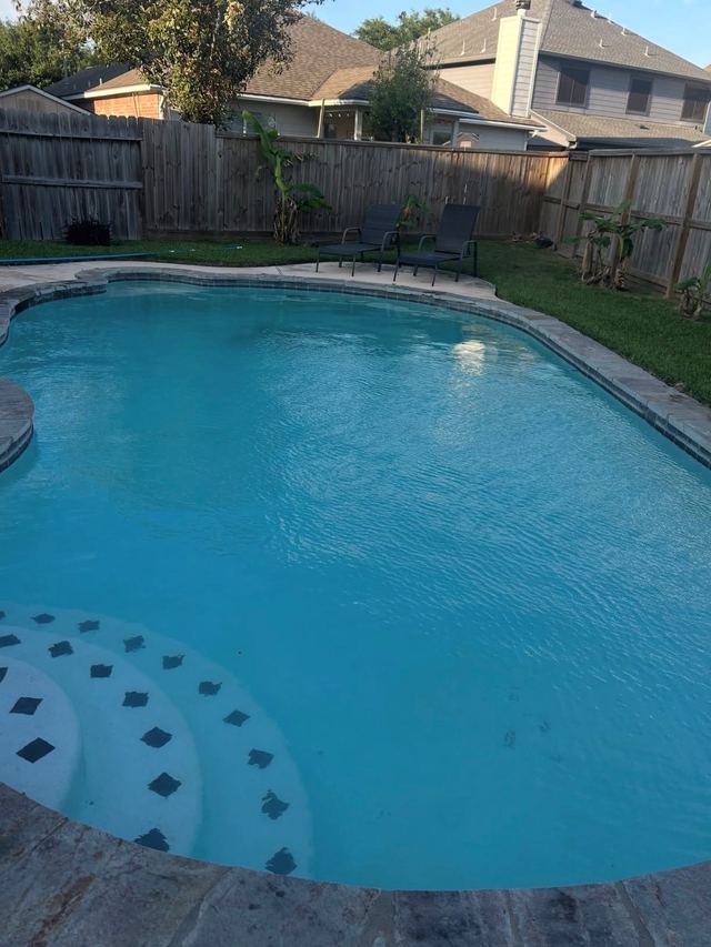 After: the same pool refilled with clear blue water, entry steps visible